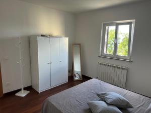 a bedroom with a bed and a dresser and a window at casa Ludovica-vista mare-giardino privato in Trieste