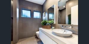 a bathroom with a sink and a toilet at Bush & Beach Retreat,Near Golf Course Yaroomba in Yaroomba