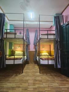 a room with three bunk beds in it at LPQ Hostel in Luang Prabang