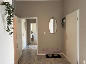 a hallway with a mirror and a tile floor at Am Conradhof 2 in Louisendorf