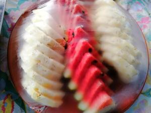 a close up of a cut up fruit on a plate at Hug Glur House Tour and Hostel in Chiang Mai +20 photos