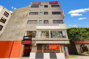 a tall building with a store in front of it at Hotel O Roux residency in New Delhi