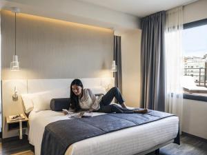 Una cama o camas en una habitación de Mercure Barcelona Condor