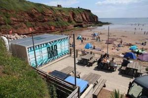 a group of people on a beach near the water at Beautiful van, beaches, accessible pet friendly in Budleigh Salterton