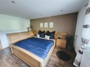 a bedroom with a large bed with blue sheets at Mondschein Apart in Pertisau