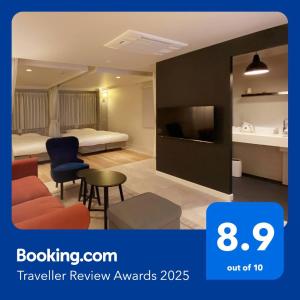 a hotel room with a bed and a tv at precious days inn in Fukuoka