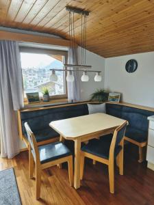a dining room with a wooden table and chairs at Mondschein Apart in Pertisau