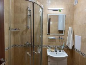 a bathroom with a shower and a sink at Апартамент Liora in Smolyan +26 photos