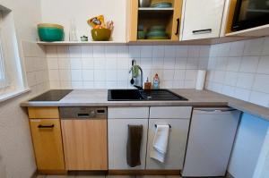 a small kitchen with a sink and a stove at Kleine Auszeit 43 in Seehausen am Staffelsee