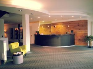 a lobby with a reception desk in a building at Hotel Scholz in Aalen