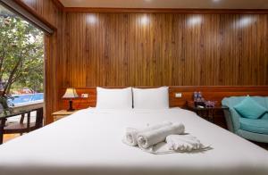 a bedroom with a bed with towels on it at Tam Coc Eco Field Nest By ANMS GROUP in Ninh Binh