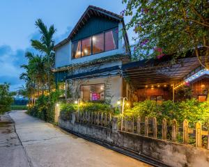 a house with a fence in front of it at Tam Coc Eco Field Nest By ANMS GROUP in Ninh Binh
