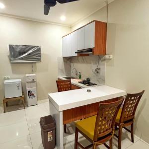 a kitchen with a counter and chairs in a room at salkhahouse bali cliff one in Ungasan