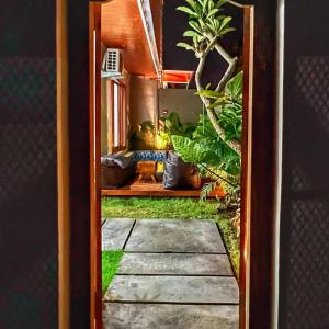 a door leading into a room with plants at salkhahouse bali cliff one in Ungasan