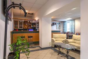 an office lobby with a couch and a table at Garni G Hotel Žilina in Žilina +36 photos
