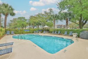 a large swimming pool with chairs and a table at 7104 Harbourside 1 in Hilton Head Island