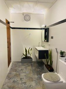 a bathroom with a toilet and a sink at Mountain Bliss - Ingiriya in Ingiriya