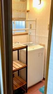 a kitchen with a washing machine and a window at Grace House Hill Paradise Atami in Atami +105 photos