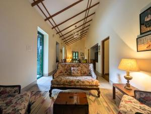 a living room with a couch and a table at Pine Tree Place By Luxunlock Private Villas in Ammatti