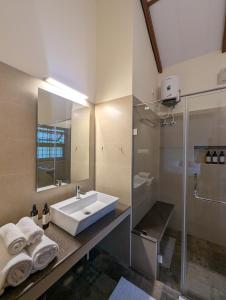 a bathroom with a sink and a shower at Pine Tree Place By Luxunlock Private Villas in Ammatti +26 photos