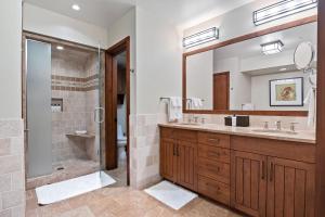 a bathroom with a shower and a large mirror at RMR: Timbers at Granite Ridge 3100 in Teton Village in Teton Village +38 photos