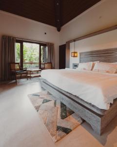 a bedroom with a large bed with a stone headboard at The Wild Rest Nature Resort in Avathi