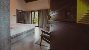 a bedroom with a bed and a window at The Wild Rest Nature Resort in Avathi +57 photos