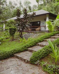 a house with a garden with stairs leading to it at The Wild Rest Nature Resort in Avathi