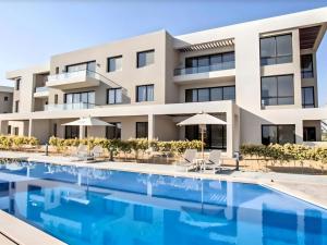 an image of a building with a swimming pool at Salty Life Chalet, Azha in Ain Sokhna