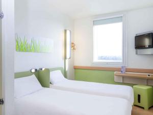 Postel nebo postele na pokoji v ubytování ibis budget Roissy CDG Paris Nord 2
