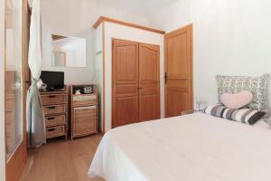 a bedroom with a bed and a desk with a television at Chambres d'hôtes St Jacques Adults only in Saint-Lizier