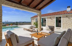 a patio with furniture and a swimming pool at Villa MilaMar by Villas Guide in Lađevci