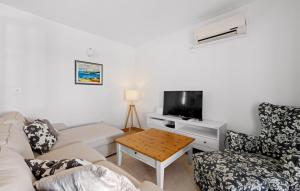 a living room with a couch and a tv and a table at Villa MilaMar by Villas Guide in Lađevci