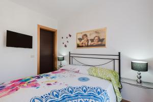 a bedroom with a bed and a picture on the wall at Casa Luna in Balestrate