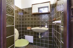 a bathroom with a sink and a toilet and a mirror at Cozy & light-filled home in Landskrona