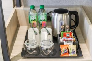 a drawer with bottles and glasses and a coffee maker at Premier Inn Abu Dhabi Capital Centre in Abu Dhabi