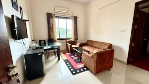a living room with a couch and a table at Hotel Mahendra, Karad in Karad