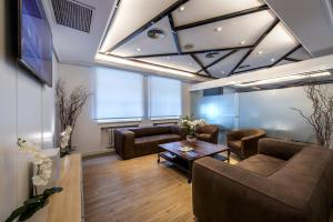 a living room with couches and a table at NeoMagna Madrid in Madrid