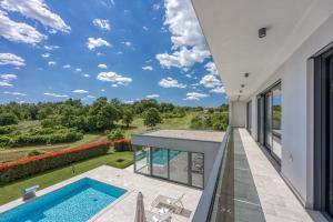 a view from the balcony of a house with a swimming pool at Contemporary Villa Nada with Pool and Sauna in Tinjan