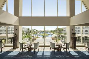 una grande stanza con tavolo e sedie e una grande finestra di Movenpick Waterpark Resort & Spa Soma Bay a Hurghada