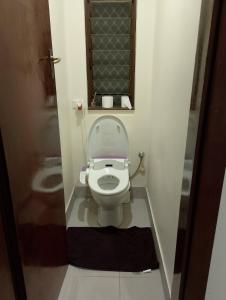 a small bathroom with a toilet with a window at 4 Bed, 1 Wash and Extra Toilet - Close to Parramatta CBD - Full House in Sydney