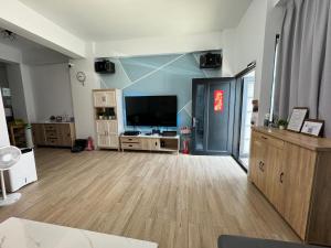 a large living room with a large flat screen tv at 夏茉二館包棟民宿 in Magong
