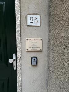 a wall with a sign on it with the number at Casa Pascucci in Manciano