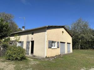 a house with two windows in a yard at La caminade in Gourbera