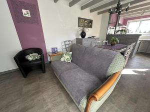 a living room with a couch and a table at La caminade in Gourbera