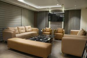 a living room with a couch and a table and chairs at Hotel Bliss express' New delhi city center in New Delhi