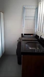 a small kitchen with a sink and a window at Apartamento 2 Quartos , Ananindeua para C0P30 in Ananindeua +8 photos