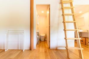 a wooden ladder in a room with a bathroom at The Nest Teshikaga in Teshikaga