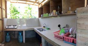 a kitchen with a sink and a counter top at Eme's Apartelle in General Luna