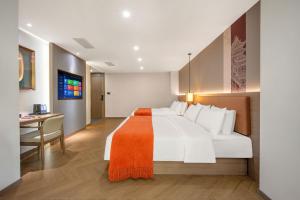 a hotel room with a large bed and a desk at Xi'an Xichen Hotel in Xi'an